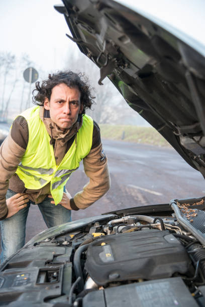 istock man with a problem with the car, with reflective vest 1216171424