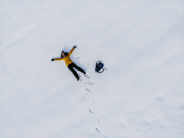 istock Aerial view woman making snow angel 1216171464