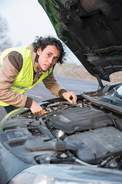 istock man with a problem with the car, with reflective vest 1216171715