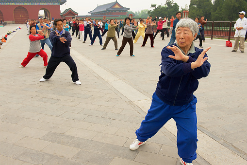 Beijing, China - May 01, 2009: Group of senior people practice tai chi chuan gymnastics outdoors in Beijing, China.