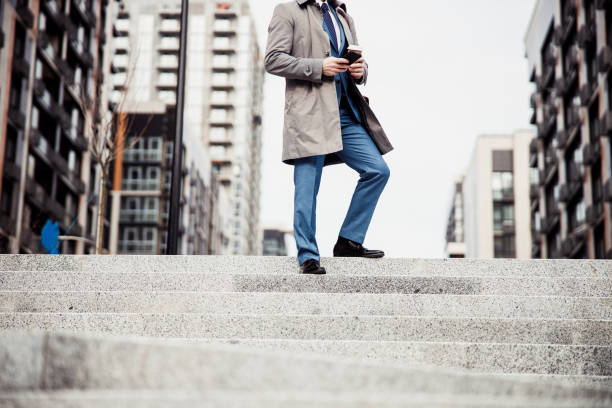 istock Male in a raincoat using a smartphone 1216173369