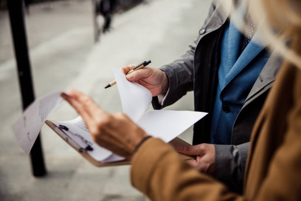 istock Broker showing a contract to his client 1216173411