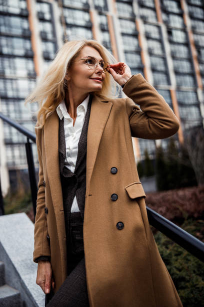 istock Relaxed woman standing near a stair railing 1216173419