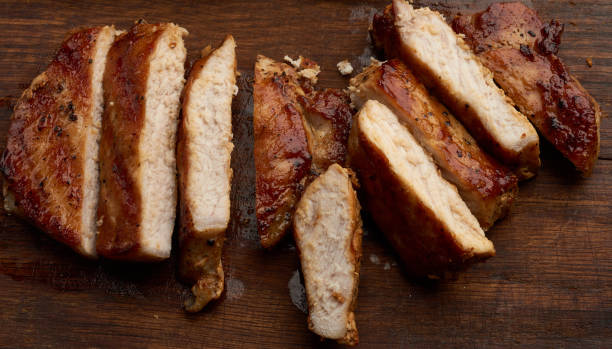 istock fried pork steak sliced on stripes on a kitchen cutting board 1216173480