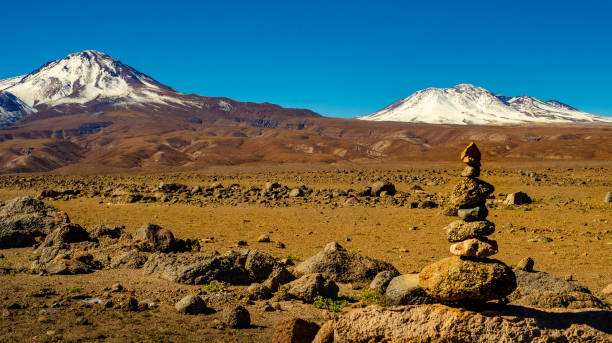 istock Vertical stones with volcanos in the desert 1216174405