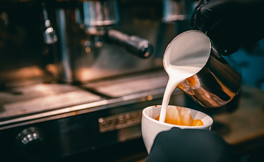 Barista hand making cappuccino Coffee with espresso machine in cafe