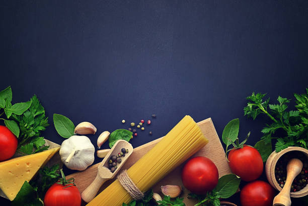 istock Tasty appetizing classic italian spaghetti pasta with tomato, cheese  and basil on dark table. View from above. Flat-lay 1216177123