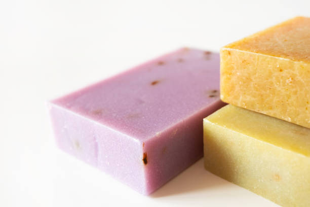 istock Close-up handmade shampoo and body barblocks with selective focus on white background. Aromatic lavender, herbal and wax soap. Health care, body care and hygiene product 1216177508