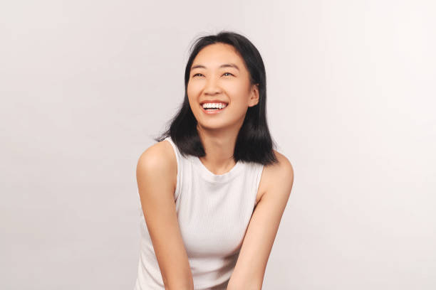 istock Girl cackles and looks up at empty space for text 1216178187