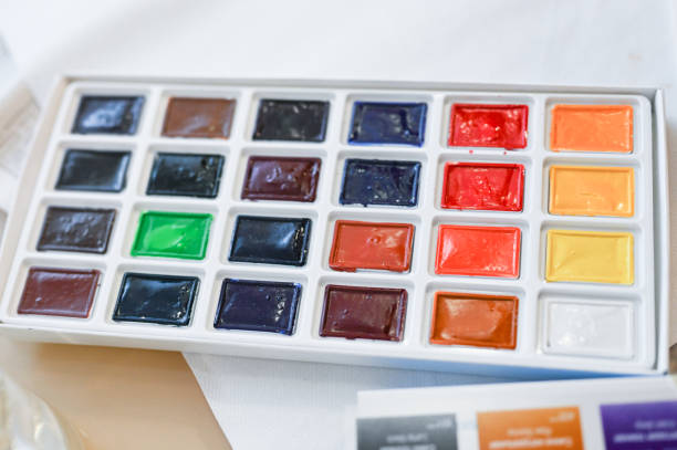 istock Multi-colored paints in squares. Watercolor paints. Close-up 1216178975