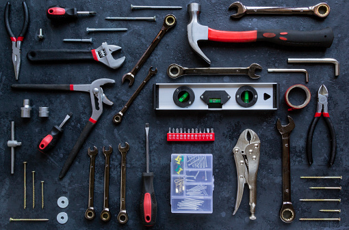 Flat lay composition with Working mechanic hand tools on grey brutal background. Black and red colors. DIY concept