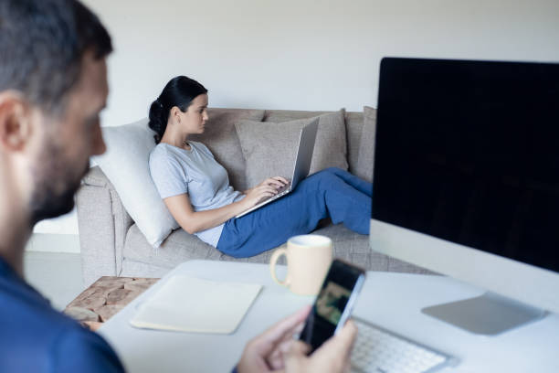 istock A young family works from home using computers. Couple working remotely online while on quarantine. Stay at home concept. Corona virus covid-19 pandemic outbreak. 1216180890