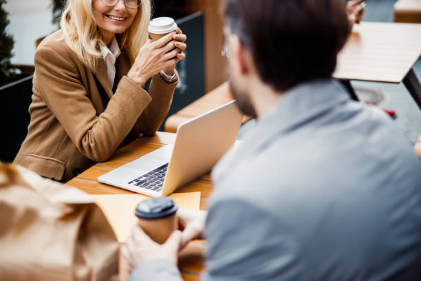 istock Two coworkers having a lunch break together 1216181934