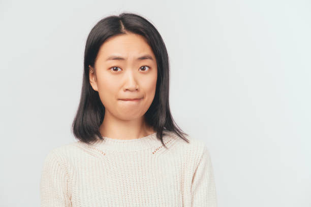 istock Portrait of disappointed scared girl bite lips 1216182192