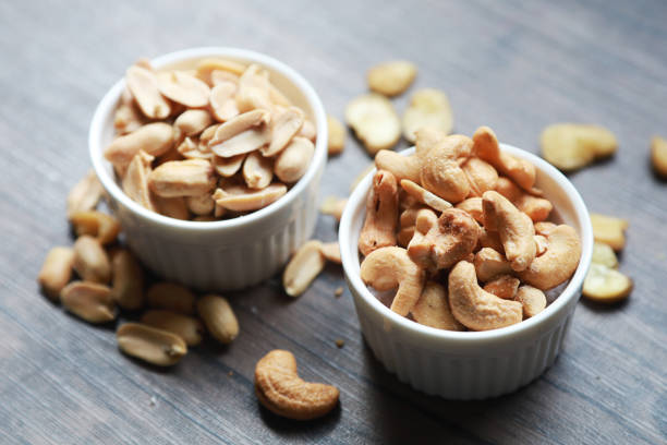 istock Peanuts and dried cashews and many other nuts along with snacks that provide high nutritional value. Put on a small white cup Place the table 1216182608