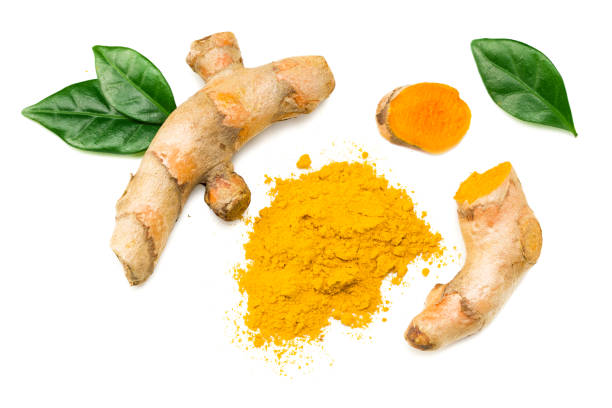 istock Turmeric powder with turmeric root isolated on white background. Top view. 1216182768