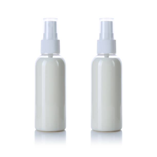 istock Transparent spray bottle with white cap filled with cream isolated on white background. Front and back view. 1216186428