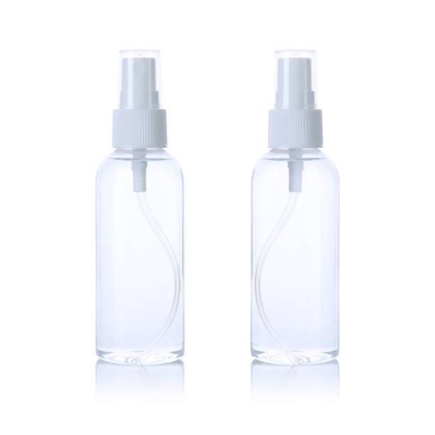 istock Transparent spray bottle with white cap filled with water isolated on white background. Front and back view. 1216186432
