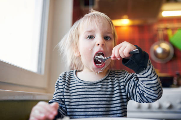 Funny Blond Baby Eating Rice On Kitchen Stock Photo - Download Image Now -  Eating, Child, Rice - Food Staple - iStock