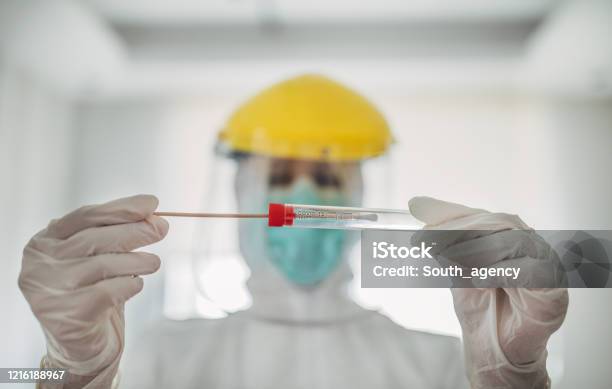 Doctor Showing Covid19 Tube Test And Sampling Swab Stock Photo - Download Image Now