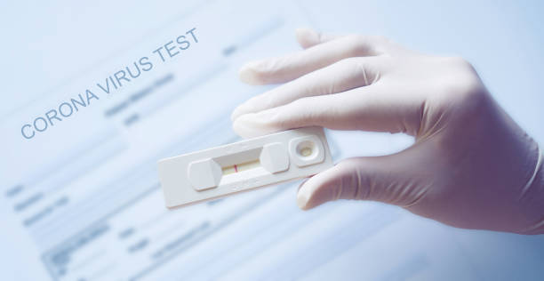 Photo of Doctor holding a test kit for viral disease COVID-19 2019-nCoV. Lab card kit test for viral novel coronavirus. Negative test result by using rapid test device for COVID-19.
