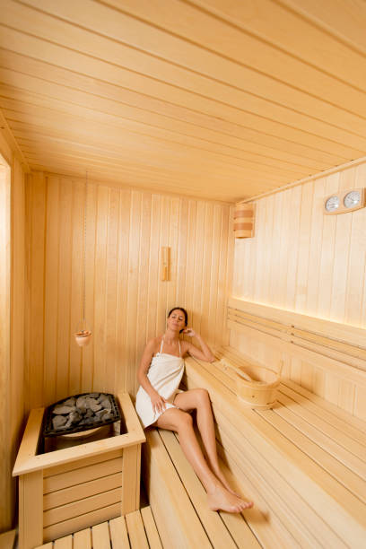 istock Young woman relaxing in the sauna 1216189988