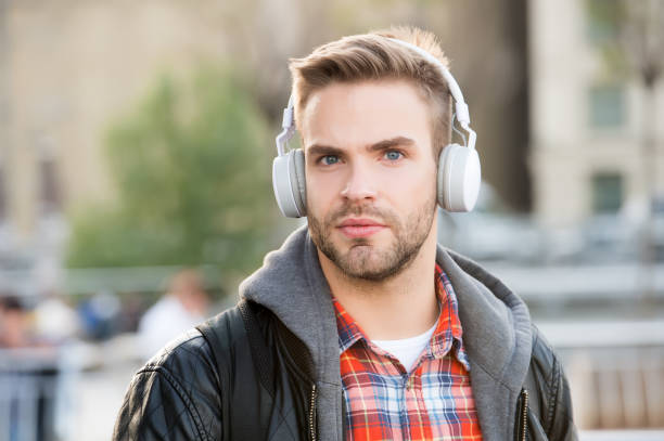 istock While walk. Online education courses. Listen music. Ebook audio concept. Student study use headphones. Handsome man urban background defocused. Distance education. Remote studying. Modern education 1216191266