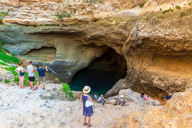 Tourists at the source of the Sorgue River, located next to the small town of Fontaine de Vaucluse in the Vaucluse department, Provence-Alpes-Côte d'Azur region.