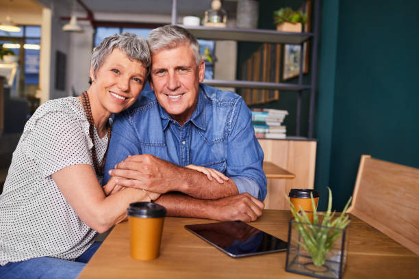 istock Smiling mature having coffee together in a cafe 1216193353