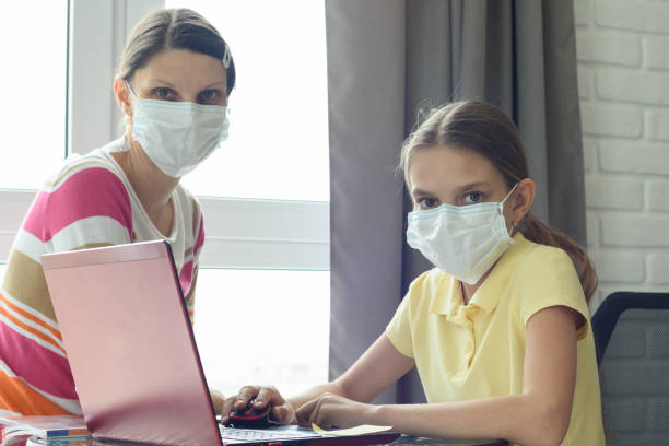 istock Quarantine mom and daughter do home lessons online 1216193796