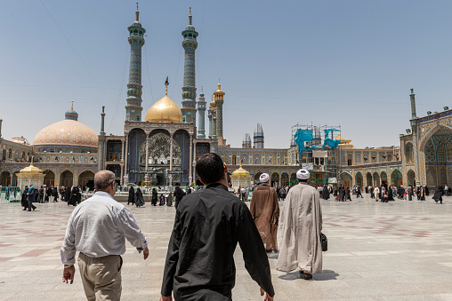 Qom- Iran. -may 14,2013: people and Mullahs with turban and long robe in the courtyard of the Fatima Masumeh shrine. Fatima Masumeh shrine is an important center of religion for sii sect.Qom- Iran. -may 14,2013: people and Mullahs with turban and long robe in the courtyard of the Fatima Masumeh shrine. Fatima Masumeh shrine is an important center of religion for sii sect.