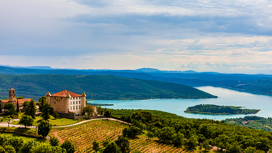 In the foreground you can see the Château d'Aiguines, a private castle; in background the lake of Sainte-Croix, located among the departments of Var and Alpes de Haute Provence.