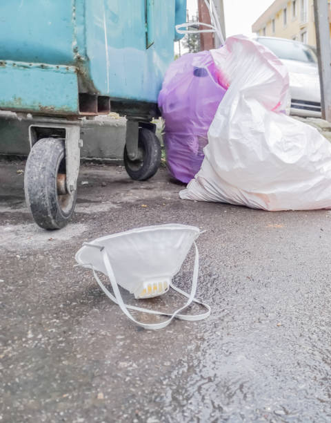istock Used protective mask on the ground 1216195617