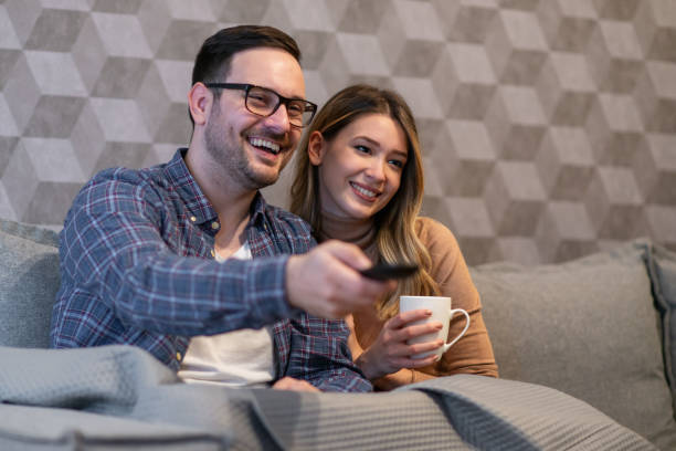 istock Cheerful young couple watching movie 1216196639