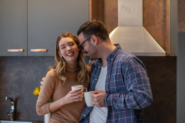 istock Cheerful young couple at home 1216196770