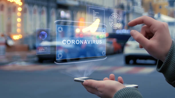 istock Female hands interact HUD hologram with text Coronavirus 1216197056