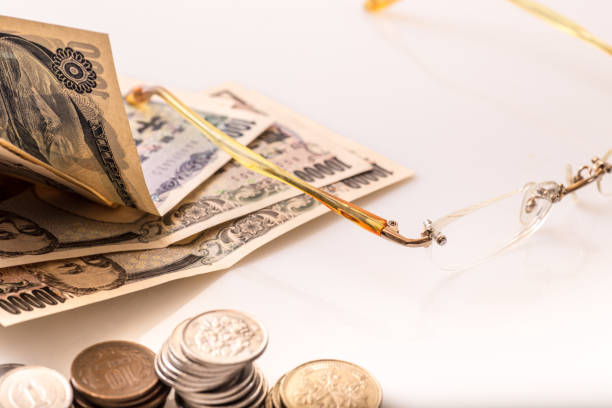 istock Japanese coins and banknotes and passport on white table 1216197086