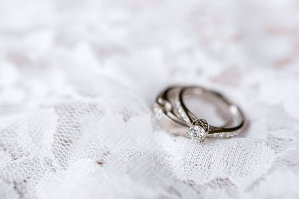 istock wedding ring on white fabric with soft-focus and over light in the background 1216197281
