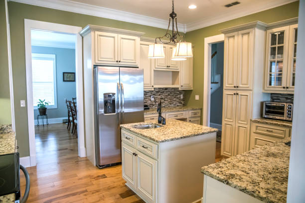 istock A square shaped green kitchen with cream colored cabinets in a new construction home with granite countertops and lots of cabinets and storage space 1216197719