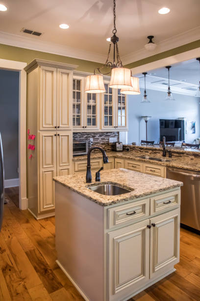 istock A square shaped green kitchen with cream colored cabinets in a new construction home with granite countertops and lots of cabinets and storage space 1216197869