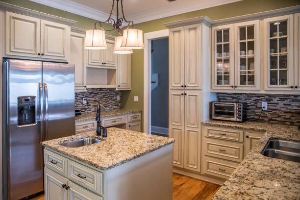 istock A square shaped green kitchen with cream colored cabinets in a new construction home with granite countertops and lots of cabinets and storage space 1216198507