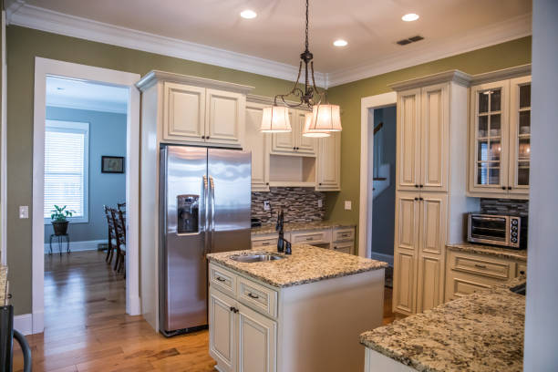 istock A square shaped green kitchen with cream colored cabinets in a new construction home with granite countertops and lots of cabinets and storage space 1216199273