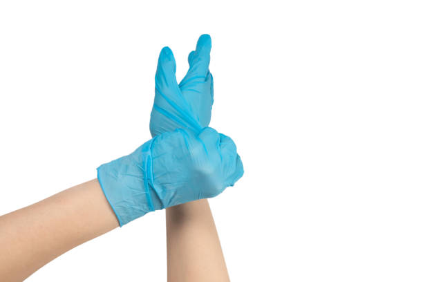 istock Woman puts on blue rubber gloves. 1216199560
