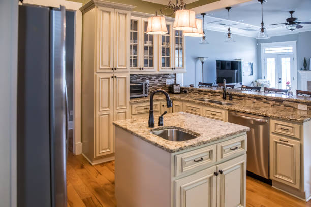 istock A square shaped green kitchen with cream colored cabinets in a new construction home with granite countertops and lots of cabinets and storage space 1216199636