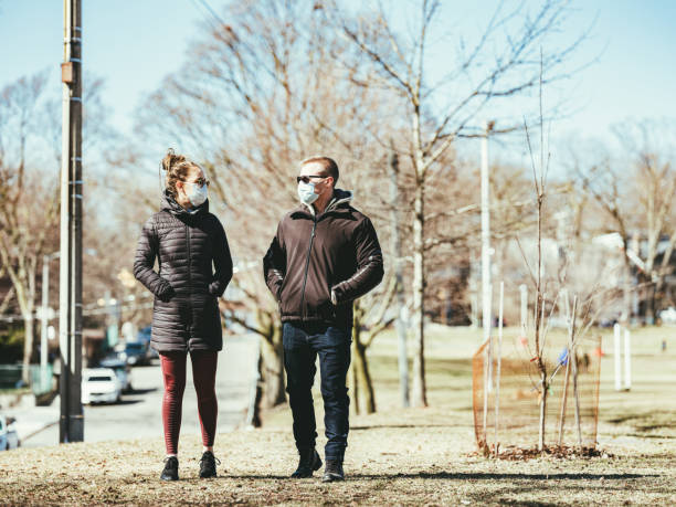 istock COVID-19, Young couple meeting outside 1216199967