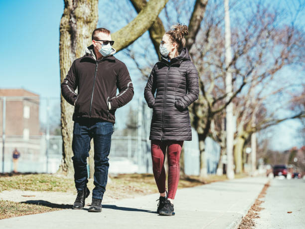 istock COVID-19, Young couple meeting outside 1216200025