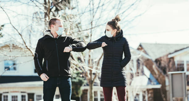 istock COVID-19, Young couple meeting outside 1216200082