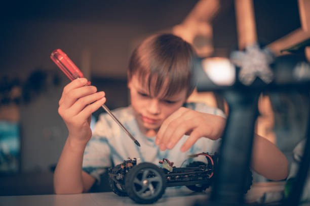 istock Kid boy repairs a remote controlled car  toy 1216200126