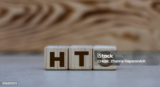 Concept Of The Word Htg On Cubes On A Gray Background With Letters Stock Photo - Download Image Now