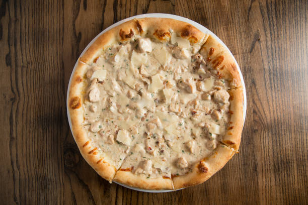 istock Pizza with cheese and chicken in carbonara sauce 1216202097